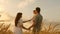 Happy baby in arms of father and mother. little daughter, dad and mom play in wheat field. baby travels across field