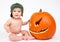 Happy baby boy with carved Pumpkin