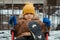 Happy baby boy child rides on swing in playground in winter