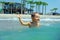 Happy baby boy enjoys swimming in sea waves