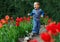 Happy baby boy running the flower garden