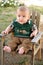 Happy baby boy on wood lawn chair