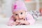 Happy baby child in pink wool costume