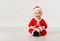 Happy baby in a Christmas costume Santa Claus with gifts