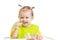 Happy baby eating with spoon sitting at table