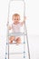 Happy baby girl on ladder