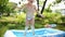 Happy baby girl little child jumps on an inflatable air mattress - slow motion HD summer