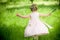 Happy baby girl outdoors with a bouquet of lilies