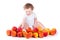 Happy baby girl playing with red and yellow apples