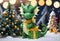 Happy baby green dragon is holding Christmas present. Generative AI