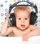 Happy baby with headphones listening to music