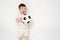 Happy baby holding a soccer ball on a studio white background. Smilin