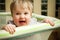 Happy baby in playpen