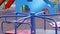 Happy baby running around the carousel in the playground.