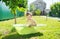 Happy baby sitting in a bath outdoor. Summer activity. Water procedure. Funny moments.