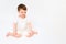 A happy baby is sitting on a studio white background. Full-length portra