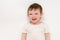 A happy baby on a studio white background. Portrait of a smiling child.