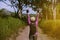 Happy backpacker asian woman standing with hands raise up and looking beautiful view at outdoor