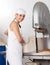 Happy Baker Using Bread Cutting Machine In Bakery