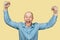 Happy bald guy office worker glad to win, smiles, laughs and raised his hands on an isolated background