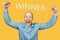 Happy bald guy office worker glad to win, smiles, laughs and raised his hands on an isolated background