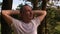 Happy bald man in white t-shirt relaxing in summer forest or park