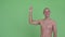 Happy bald multi ethnic shirtless man pointing up and giving thumbs up