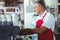 Happy barista using the coffee machine