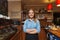 Happy barista woman at coffee shop