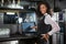 Happy barmaid preparing a bill