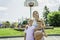 Happy basketball family portrait play this sport on summer season. The mother play with boy