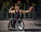 Happy basketball player in wheelchair pose with a ball on open gaming ground.