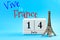 Happy Bastille day and French national day concept with a block calendar set on July 14, a miniature of the Eiffel Tower isolated