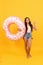 happy beach child with donut inflatable ring for pool party fun on summer vacation, summer.