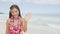 Happy beach woman waving hands hello on Hawaii