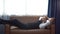 Happy  bearded business man take a break jumping to lying  down on sofa  by window in office Sleeps during the day