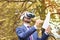 Happy bearded businessman with virtual reality glasses signs documents in autumn park. Electronic signature, Future technology or