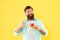 happy bearded guy drink morning coffee show thumb up on yellow background, coffee