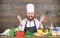 Happy bearded man cooking in kitchen. Dieting with organic food. Fresh vegetables. Vitamin. man use kitchenware