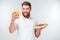 Happy bearded man having healthy snack with vegetables