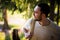 Happy bearded man traveler with backpack walking in forest. Tourism, travel, adventure, hike concept - smiling young man