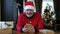 Happy beared senior man in red christmas sweater talking on the smart phone, video call