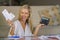 Happy and beautiful 40s blond woman smiling relaxed calculating successful domestic money income and financial monthly business po