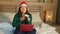 Happy and beautiful Asian American girl in Santa Christmas hat using credit card and laptop computer for online shopping