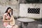 Happy beautiful Asian Chinese woman artist in traditional chi-pao cheongsam in a garden play musical instruments pipa Chinese lute
