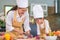 Happy beautiful Asian woman and cute little boy with eyeglasses prepare to cooking in home kitchen. People lifestyles and Family.