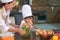 Happy beautiful Asian woman and cute little boy with eyeglasses prepare to cooking in kitchen at home. People lifestyles and