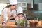 Happy beautiful Asian woman and cute little boy with eyeglasses prepare to cooking in kitchen at home. People lifestyles and