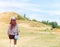 Happy Beautiful Asian Woman with Hat and Bag Ready to Start Vacation at The Corner with Scenery Mountain in Background