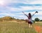 Happy Beautiful Asian Woman with Hat and Bag Ready to Start Vacation at The Corner with Scenery Mountain in Background